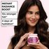Woman holding Garnier Grape Moisture hair mask beside product benefits