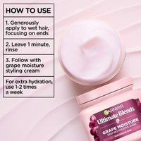 Open Garnier Grape Moisture hair mask jar with application instructions