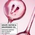Cut grape and liquid splash illustrating grape water and grapeseed oil