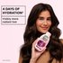 Woman holding Garnier Grape Moisture shampoo beside a hydration claim